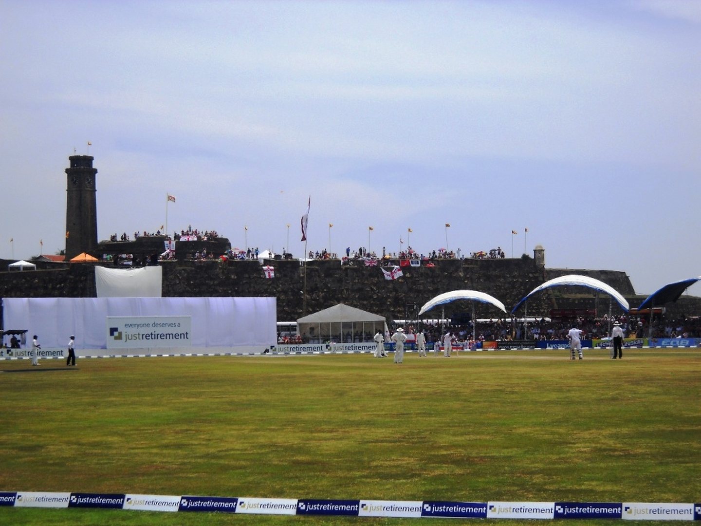 Test cricket in progress at Galle International Stadium with the Dutch fort ramparts behind