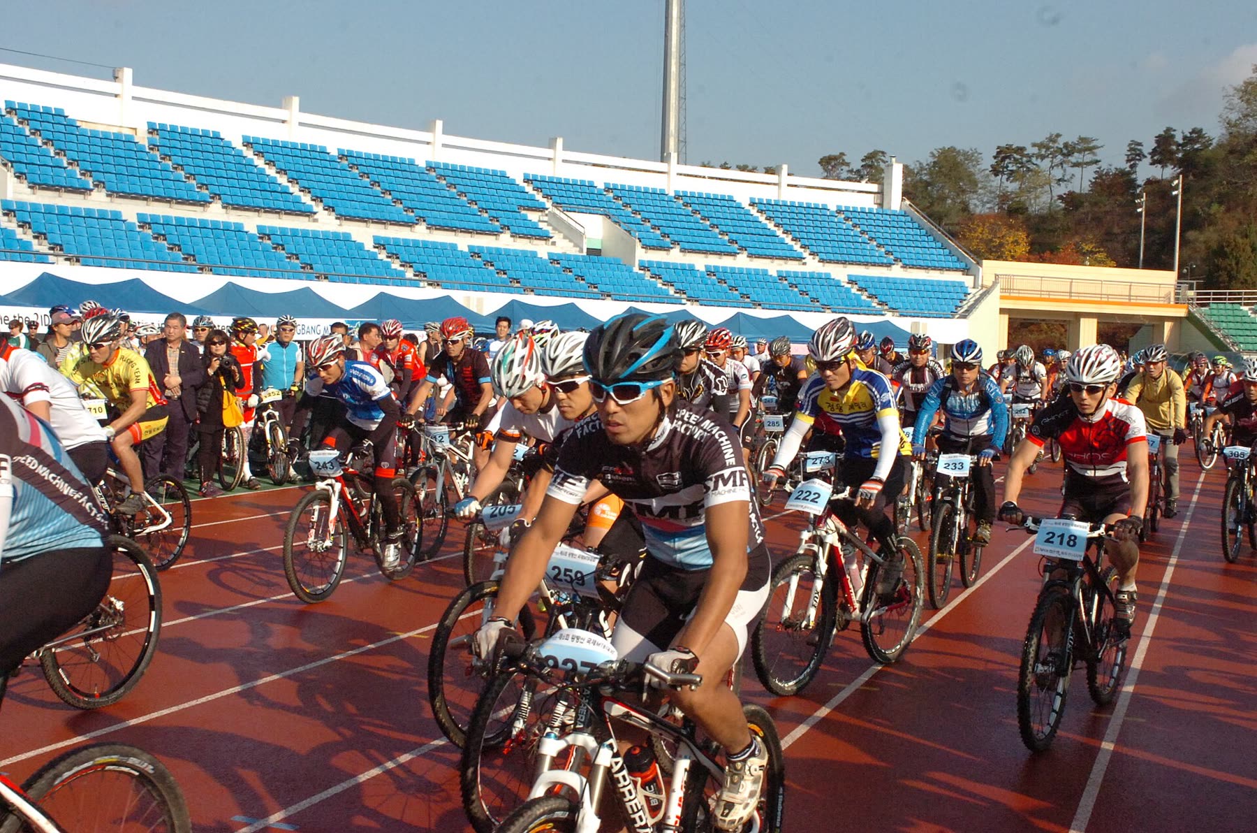 Large group of cyclists at the start line of a ride in South Korea